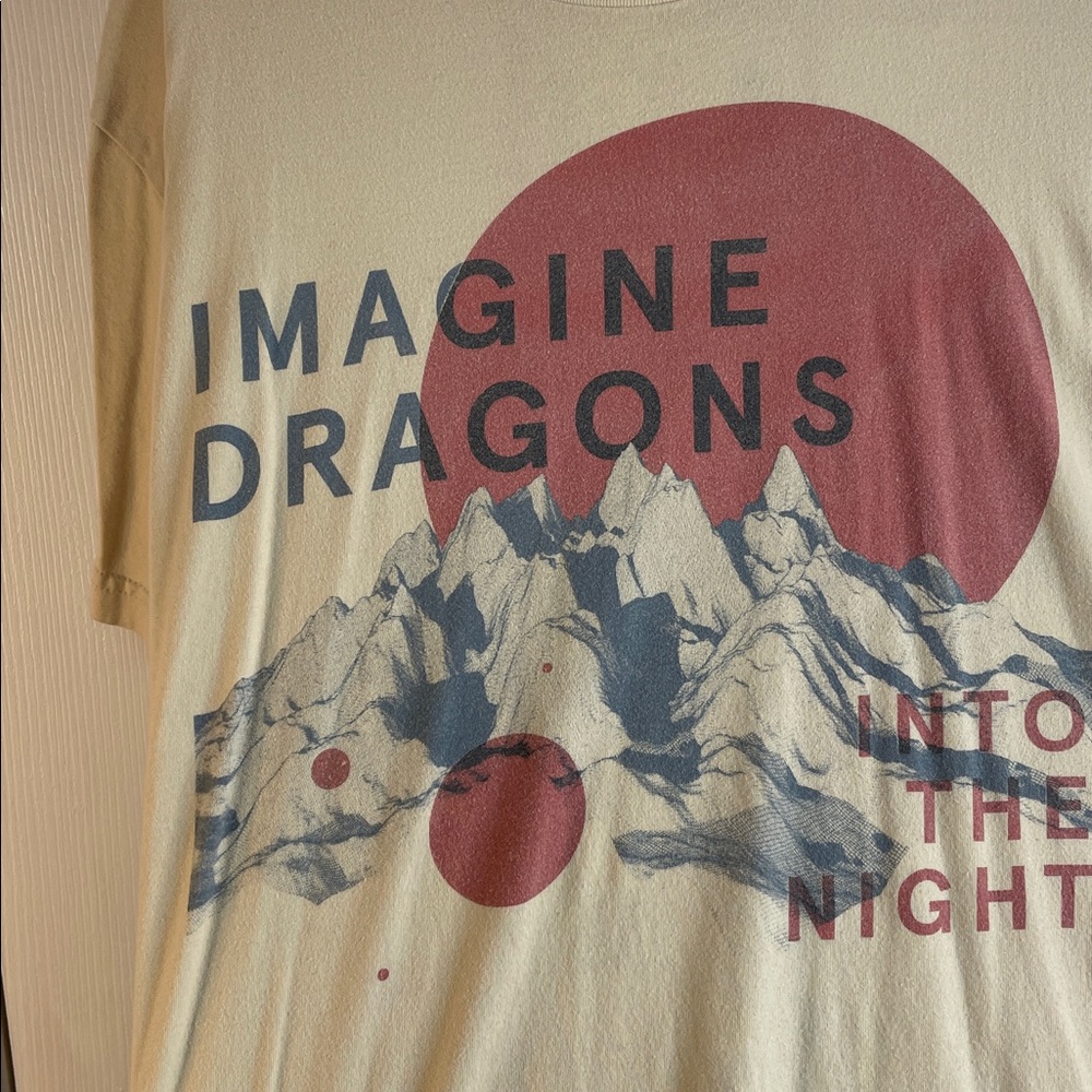 Imagine Dragons Beige Graphic T-Shirt with Red and Blue Design.